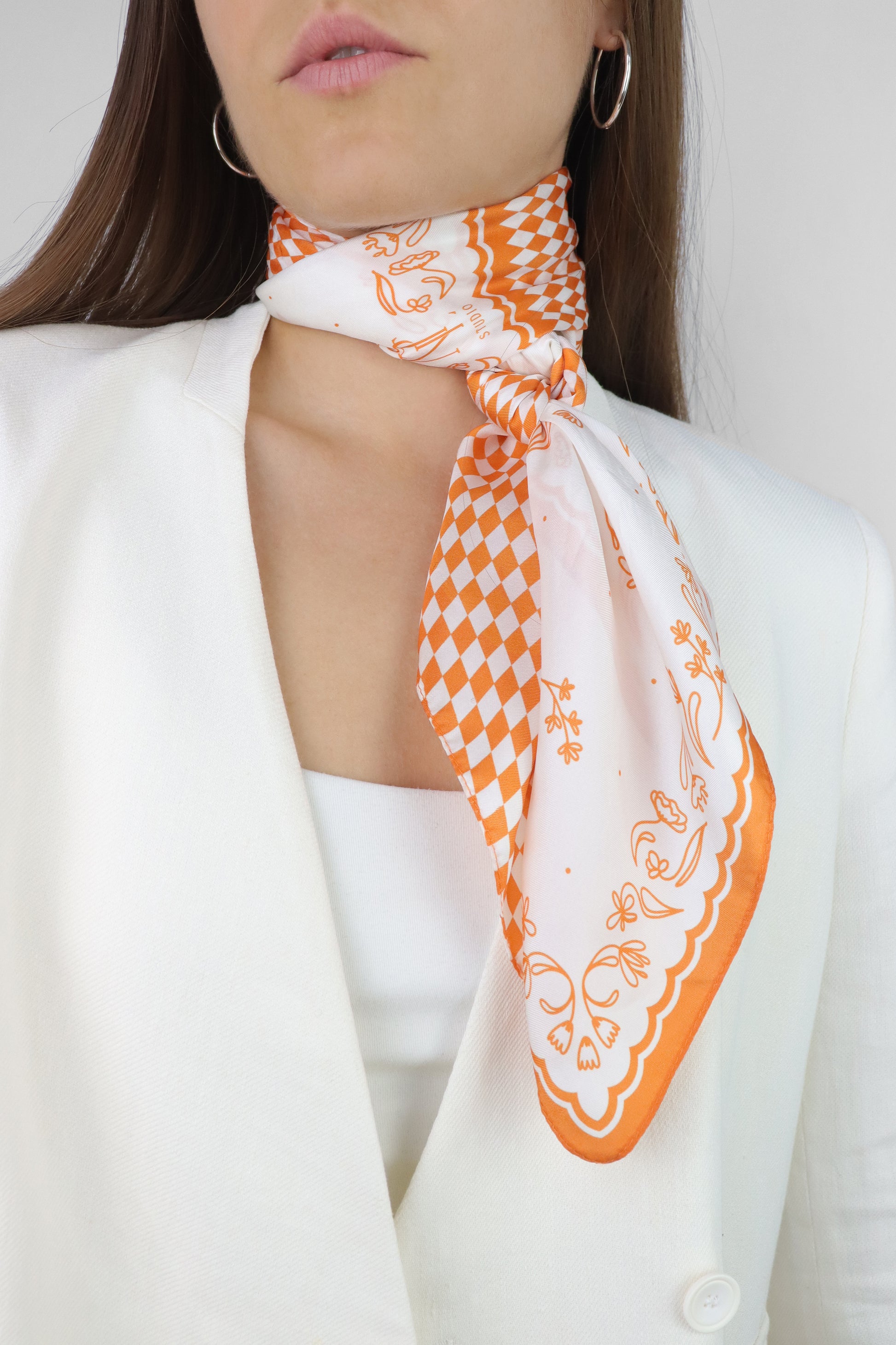 https://esntlstudio.com/cdn/shop/files/Esntl-Studio_Orange_silk-scarf_neck-scarf_bandana_head-scarf_neckerchief_floral_geometric_caro_model7.jpg?v=1689780076&width=1946